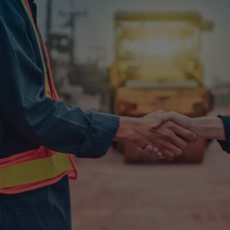 Two professionals shaking hands, closing a deal for a successful partnership. Representing growth and trust in the industry.